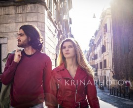 Beautiful couple traveling to Rome. Young couple went shopping and walks through the streets of the historic center of the city. Shopping concept.