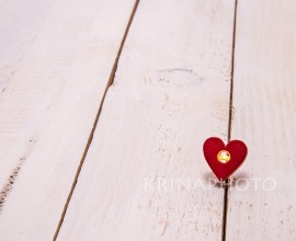 A small light inside a heart on a white wooden background. To express love with a simple and deep thought.